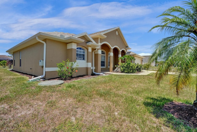 5940 NW Center St, Port Saint Lucie, FL 34986 - view of front of property with stucco siding, an attached garage, and a front yard