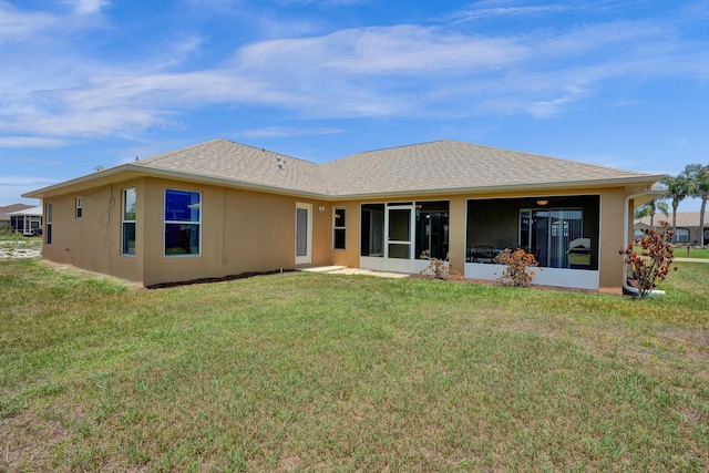 5940 NW Center St, Port Saint Lucie, FL 34986 - back of house with a sunroom, a lawn, and stucco siding