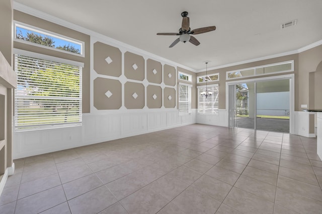 198 Magnolia Lakes Blvd, Port Saint Lucie, FL 34986 - spare room featuring a ceiling fan, ornamental molding, a decorative wall, tile patterned floors, and plenty of natural light