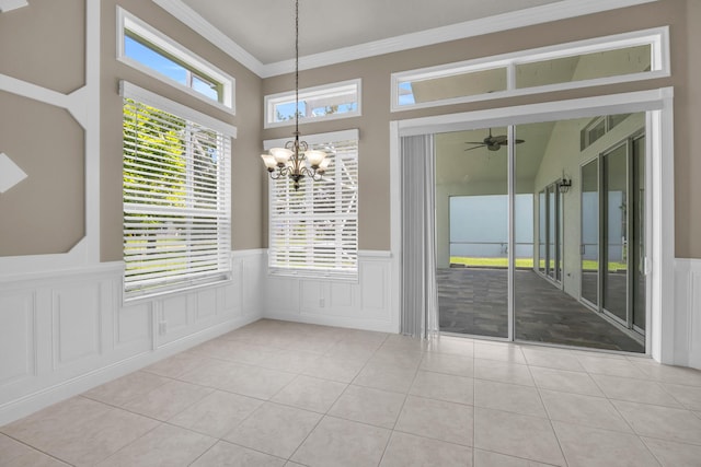 198 Magnolia Lakes Blvd, Port Saint Lucie, FL 34986 - unfurnished dining area with a chandelier, ornamental molding, tile patterned floors, a wainscoted wall, and a ceiling fan