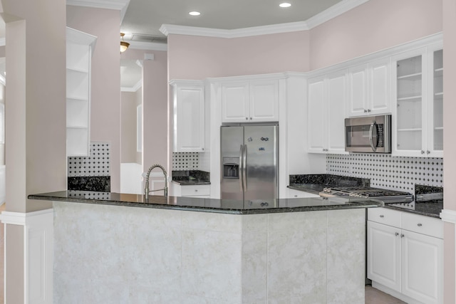 198 Magnolia Lakes Blvd, Port Saint Lucie, FL 34986 - kitchen with appliances with stainless steel finishes, ornamental molding, tasteful backsplash, dark stone countertops, and white cabinets