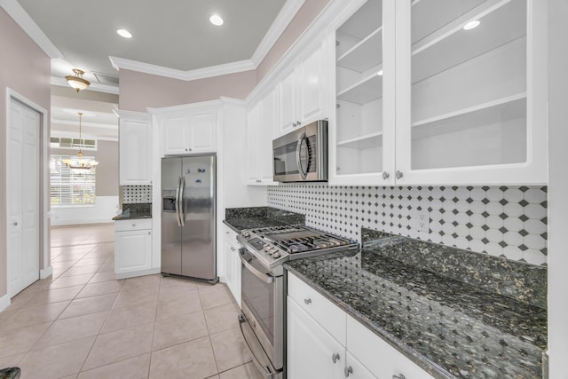 198 Magnolia Lakes Blvd, Port Saint Lucie, FL 34986 - kitchen featuring stainless steel appliances, ornamental molding, white cabinets, decorative backsplash, and dark stone countertops