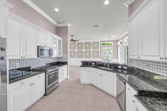 198 Magnolia Lakes Blvd, Port Saint Lucie, FL 34986 - kitchen featuring stainless steel appliances, white cabinets, backsplash, ornamental molding, and ceiling fan