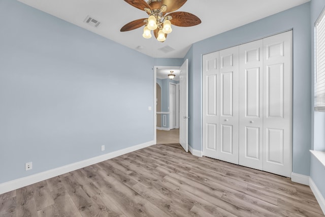 198 Magnolia Lakes Blvd, Port Saint Lucie, FL 34986 - unfurnished bedroom featuring baseboards, wood finished floors, a closet, and a ceiling fan