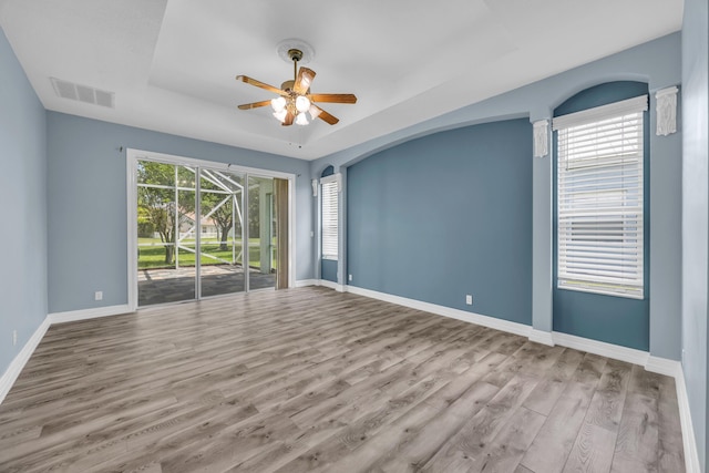 198 Magnolia Lakes Blvd, Port Saint Lucie, FL 34986 - spare room featuring ceiling fan, wood finished floors, baseboards, and a raised ceiling