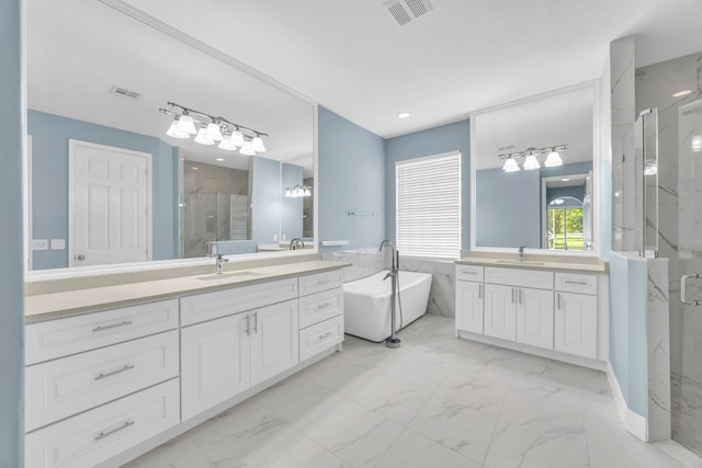 198 Magnolia Lakes Blvd, Port Saint Lucie, FL 34986 - bathroom with marble finish flooring, a marble finish shower, two vanities, a freestanding tub, and tile walls