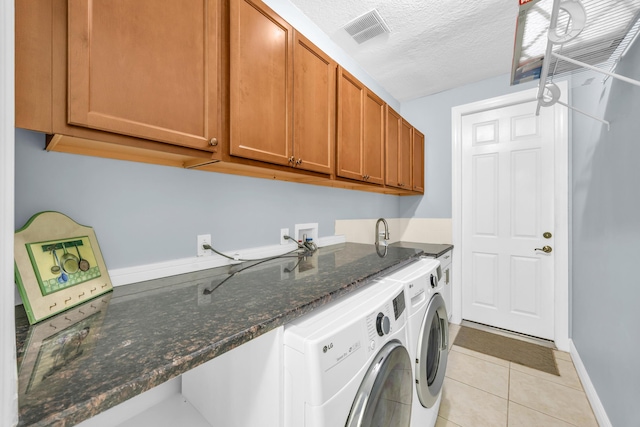 198 Magnolia Lakes Blvd, Port Saint Lucie, FL 34986 - laundry area featuring separate washer and dryer, cabinet space, light tile patterned flooring, a textured ceiling, and baseboards