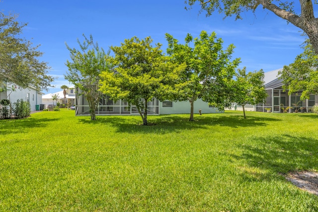 198 Magnolia Lakes Blvd, Port Saint Lucie, FL 34986 - view of grassy yard with a sunroom