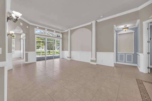 198 Magnolia Lakes Blvd, Port Saint Lucie, FL 34986 - empty room with light tile patterned floors, a wainscoted wall, a decorative wall, ornamental molding, and arched walkways