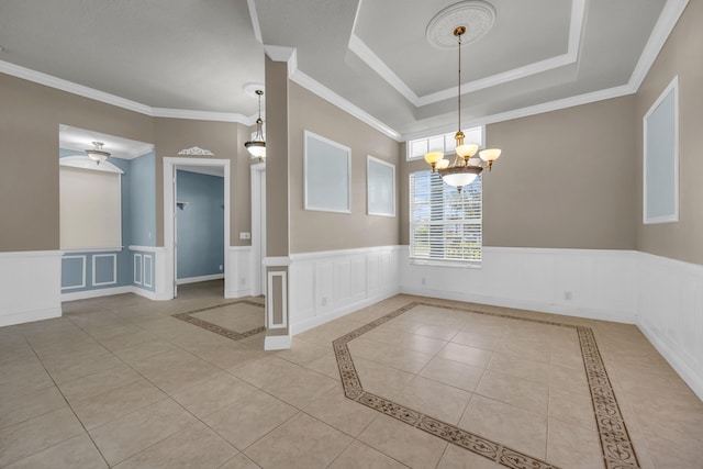 198 Magnolia Lakes Blvd, Port Saint Lucie, FL 34986 - tiled empty room with a chandelier, ornamental molding, a decorative wall, and wainscoting