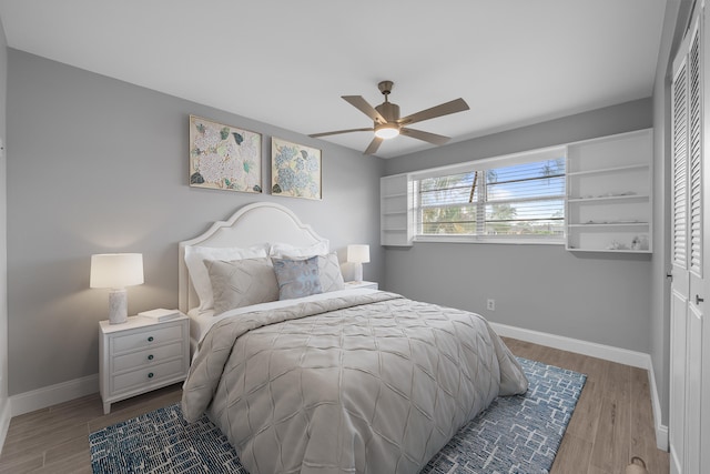 2950 SE Ocean Blvd Unit 9-5, Stuart, FL 34996 - bedroom featuring baseboards, wood finished floors, a closet, and ceiling fan