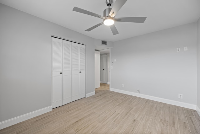 2950 SE Ocean Blvd Unit 9-5, Stuart, FL 34996 - unfurnished bedroom with light wood-type flooring, baseboards, a closet, and a ceiling fan