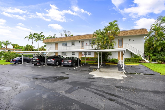 2950 SE Ocean Blvd Unit 9-5, Stuart, FL 34996 - partially covered parking lot featuring stairs