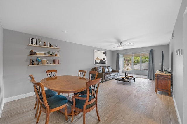 2950 SE Ocean Blvd Unit 9-5, Stuart, FL 34996 - dining area featuring ceiling fan, light wood finished floors, and baseboards