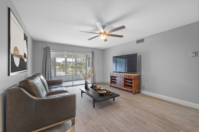 2950 SE Ocean Blvd Unit 9-5, Stuart, FL 34996 - living room featuring a ceiling fan, baseboards, and light wood-type flooring