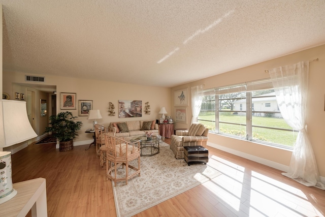 14240 Nesting Way Unit D, Delray Beach, FL 33484 - living area with a textured ceiling, wood finished floors, and baseboards