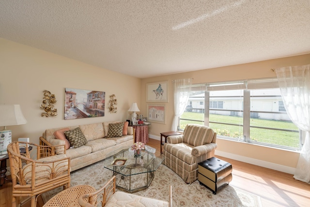 14240 Nesting Way Unit D, Delray Beach, FL 33484 - living area with wood finished floors, baseboards, and a textured ceiling