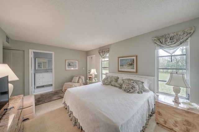 14240 Nesting Way Unit D, Delray Beach, FL 33484 - bedroom featuring light colored carpet, a textured ceiling, and a closet