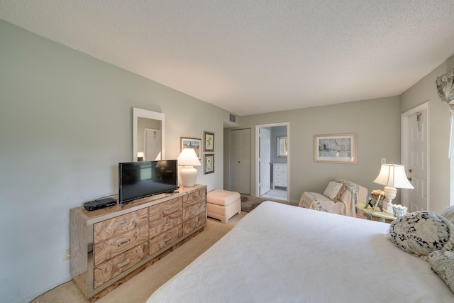 14240 Nesting Way Unit D, Delray Beach, FL 33484 - bedroom with light colored carpet, a textured ceiling, and connected bathroom