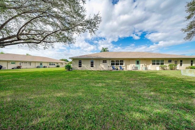 14240 Nesting Way Unit D, Delray Beach, FL 33484 - rear view of property featuring a yard