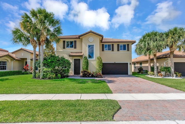 5014 Manchia Dr, Lake Worth, FL 33463 - mediterranean / spanish home with a garage, decorative driveway, stucco siding, a tiled roof, and a front lawn