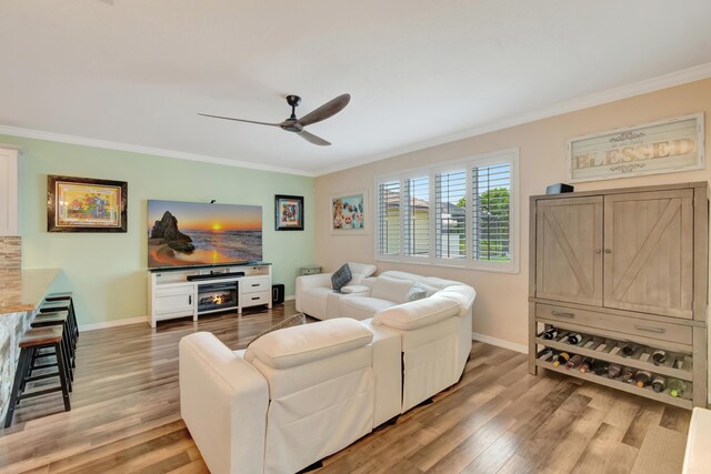 5014 Manchia Dr, Lake Worth, FL 33463 - living area with ornamental molding, a ceiling fan, baseboards, and light wood-style flooring
