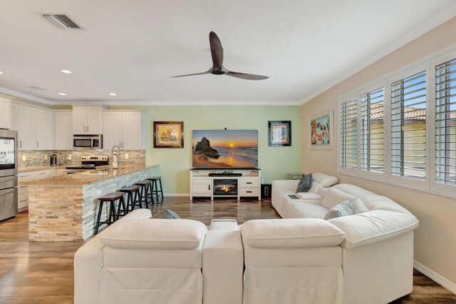 5014 Manchia Dr, Lake Worth, FL 33463 - living area featuring wood finished floors, crown molding, ceiling fan, baseboards, and recessed lighting