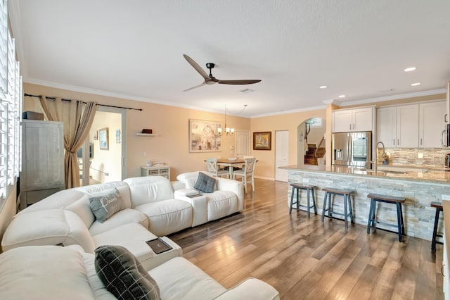 5014 Manchia Dr, Lake Worth, FL 33463 - living room featuring light wood finished floors, crown molding, ceiling fan, recessed lighting, and a chandelier