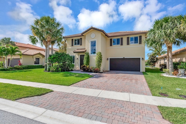 5014 Manchia Dr, Lake Worth, FL 33463 - mediterranean / spanish house with a garage, decorative driveway, stucco siding, and a tile roof