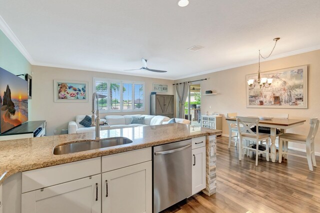 5014 Manchia Dr, Lake Worth, FL 33463 - kitchen with dishwasher, a sink, white cabinets, ornamental molding, and a chandelier
