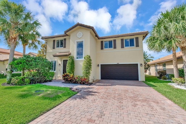 5014 Manchia Dr, Lake Worth, FL 33463 - mediterranean / spanish-style home featuring an attached garage, decorative driveway, stucco siding, and a front yard
