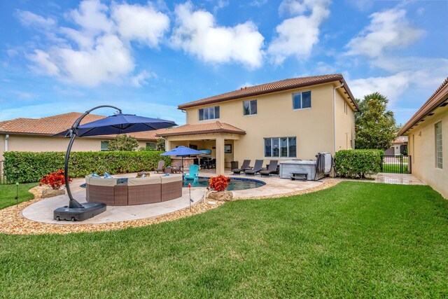 5014 Manchia Dr, Lake Worth, FL 33463 - rear view of house with a hot tub, outdoor lounge area, a patio area, stucco siding, and a tile roof