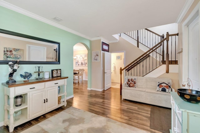 5014 Manchia Dr, Lake Worth, FL 33463 - living area featuring wood finished floors, arched walkways, ornamental molding, baseboards, and stairs