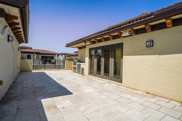 65 NE 4th Ave Unit I, Delray Beach, FL 33483 - view of patio featuring french doors