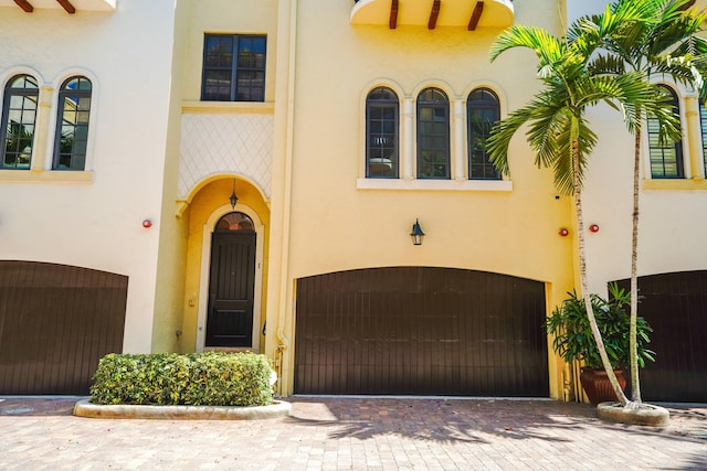 65 NE 4th Ave Unit I, Delray Beach, FL 33483 - mediterranean / spanish-style home featuring stucco siding, a garage, and driveway
