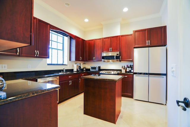 65 NE 4th Ave Unit I, Delray Beach, FL 33483 - kitchen featuring dark brown cabinets, freestanding refrigerator, stainless steel microwave, ornamental molding, and a kitchen island