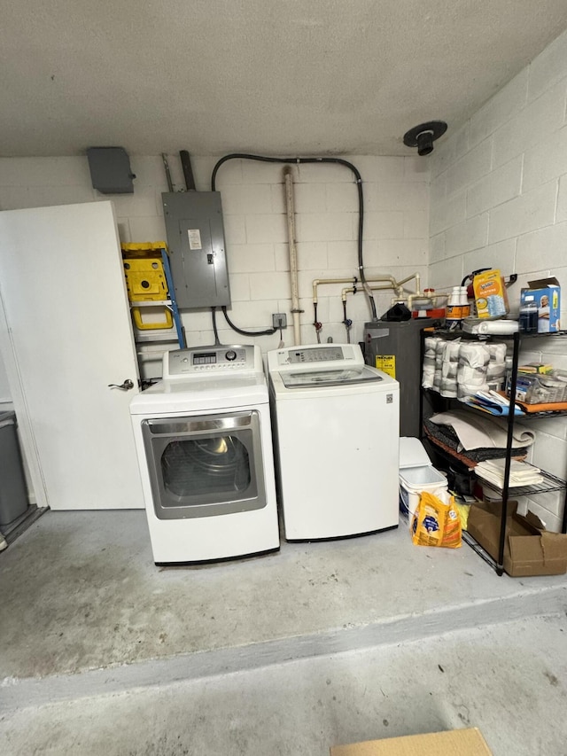 308 Florida Ave, Winter Garden, FL 34787 - laundry room featuring electric panel, washer and clothes dryer, concrete block wall, and water heater
