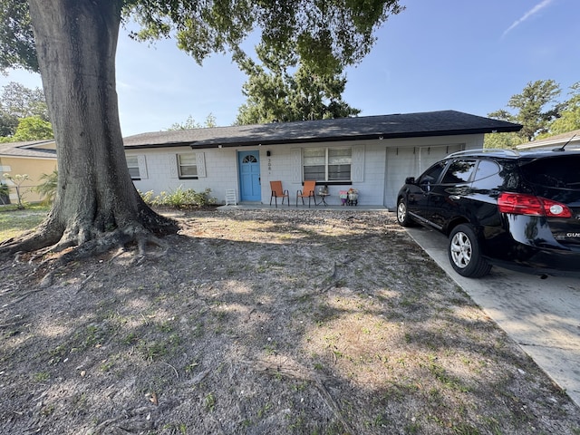 308 Florida Ave, Winter Garden, FL 34787 - single story home with concrete block siding, a garage, and roof with shingles