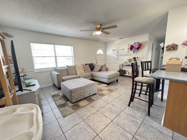 308 Florida Ave, Winter Garden, FL 34787 - living room featuring a ceiling fan, light tile patterned floors, and a textured ceiling