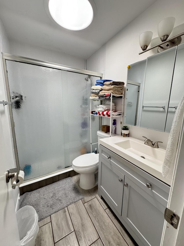 308 Florida Ave, Winter Garden, FL 34787 - full bathroom with toilet, a shower stall, vanity, and wood finished floors