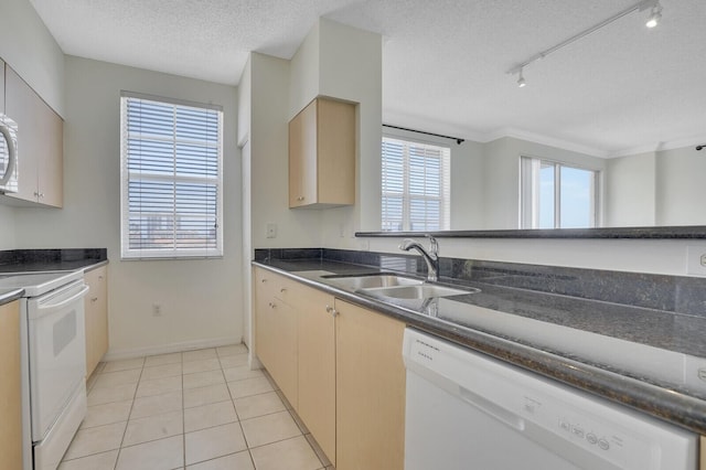 616 Clearwater Park Rd Unit 812, West Palm Beach, FL 33401 - kitchen with white appliances, a sink, a textured ceiling, track lighting, and baseboards