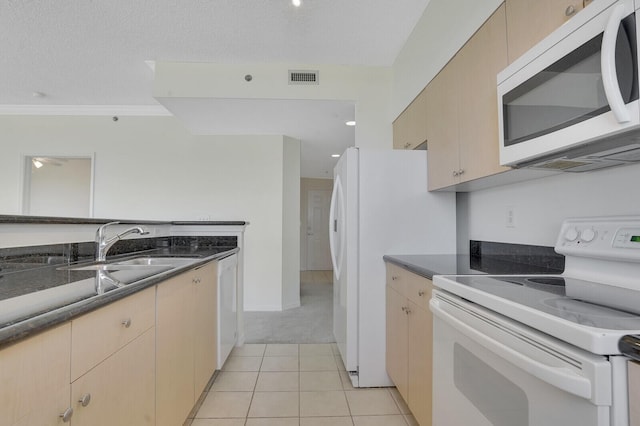 616 Clearwater Park Rd Unit 812, West Palm Beach, FL 33401 - kitchen with white appliances, a sink, light brown cabinetry, light tile patterned floors, and light colored carpet