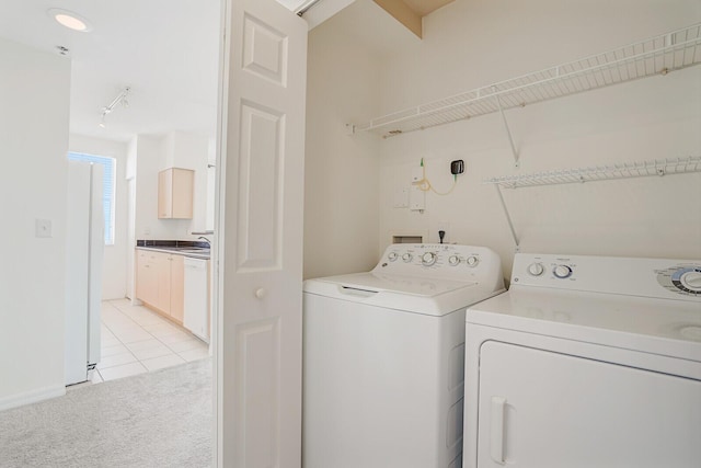616 Clearwater Park Rd Unit 812, West Palm Beach, FL 33401 - laundry area with independent washer and dryer, light carpet, and light tile patterned floors