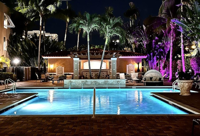 616 Clearwater Park Rd Unit 812, West Palm Beach, FL 33401 - pool at twilight with a community pool and a patio