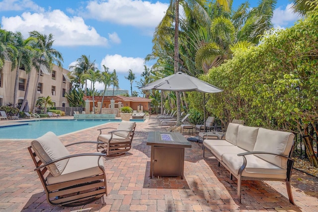 616 Clearwater Park Rd Unit 812, West Palm Beach, FL 33401 - community pool with a patio and an outdoor living space with a fire pit