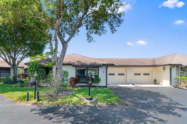 4657 Greentree Pl Unit A, Boynton Beach, FL 33436 - ranch-style home with an attached garage, stucco siding, driveway, and a front lawn