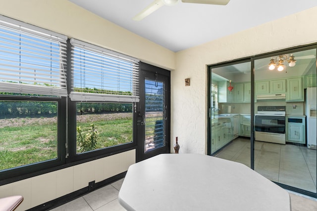 4657 Greentree Pl Unit A, Boynton Beach, FL 33436 - dining room with light tile patterned flooring, a textured wall, and a ceiling fan