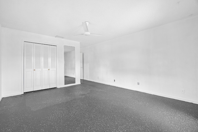 4657 Greentree Pl Unit A, Boynton Beach, FL 33436 - unfurnished bedroom with speckled floor, baseboards, a ceiling fan, and a closet