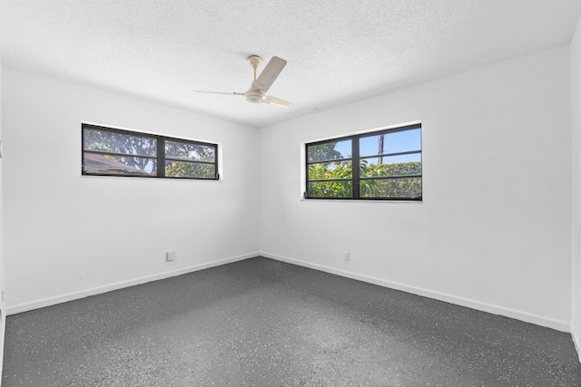 4657 Greentree Pl Unit A, Boynton Beach, FL 33436 - unfurnished room featuring a ceiling fan, baseboards, a textured ceiling, and speckle patterned floor