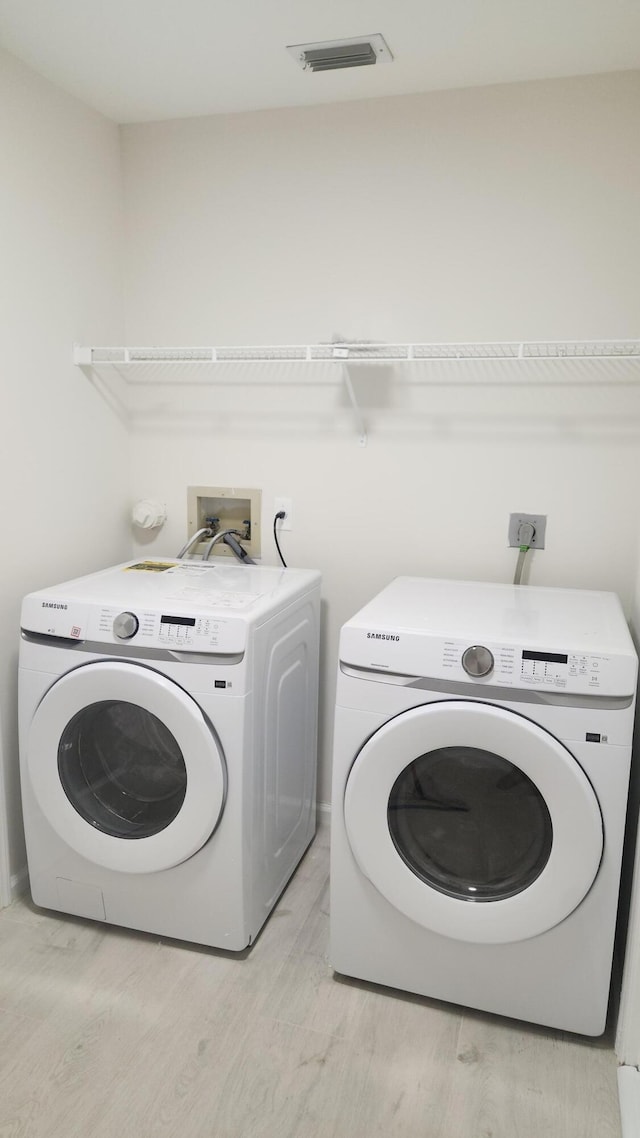2012 White Coral Ct, Wellington, FL 33414 - washroom featuring washer and clothes dryer and light wood finished floors